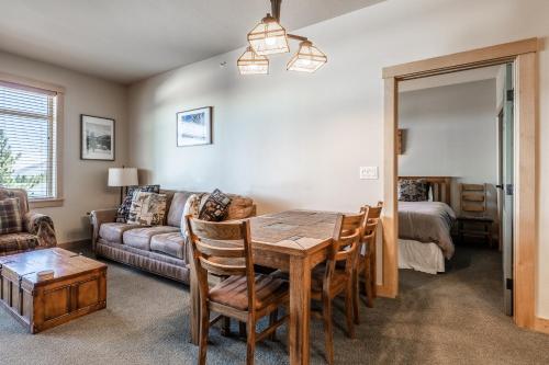 a living room with a dining room table and a couch at Sunstone # 329 in Mammoth Lakes