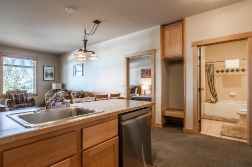 a kitchen with a sink and a living room at Sunstone # 329 in Mammoth Lakes