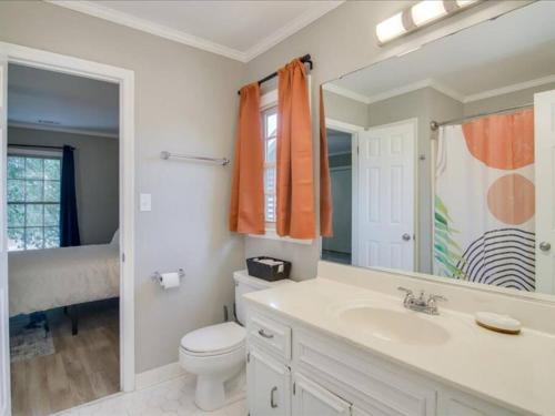 a bathroom with a sink and a toilet and a mirror at Beacon House, Central to Augusta in Augusta