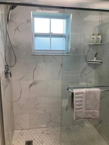 a bathroom with a shower with a glass door at Golf Coast Charmer in Bradenton