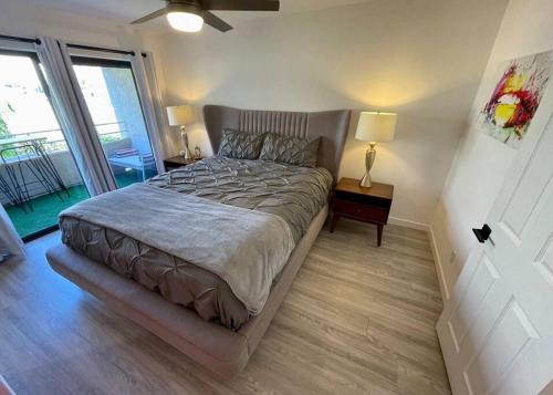 a bedroom with a bed and a large window at MCM Condo Downtown Palm Springs in Palm Springs