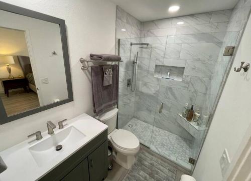 een badkamer met een douche, een toilet en een wastafel bij MCM Condo Downtown Palm Springs in Palm Springs