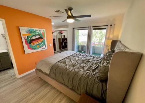 a bedroom with a bed and a ceiling fan at MCM Condo Downtown Palm Springs in Palm Springs