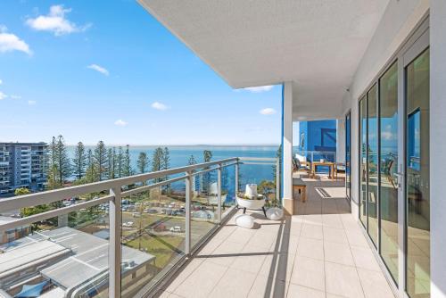 an apartment balcony with a view of the ocean at Proximity Waterfront Apartments in Redcliffe