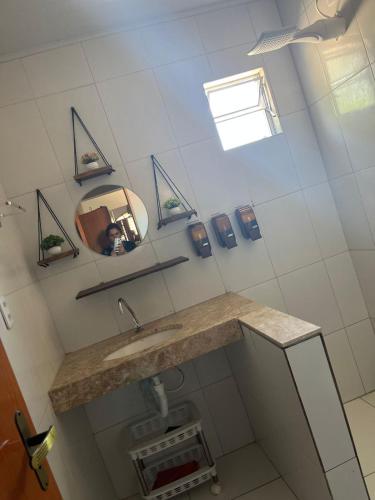 a bathroom with a sink and a mirror at Canto da Gaivota Lençóis Maranhenses in Santo Amaro