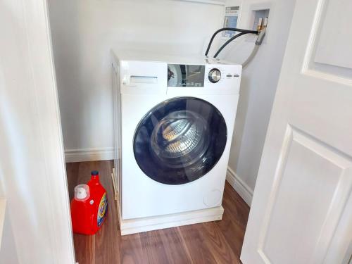 a washer and dryer in a laundry room at Tranquil Retreat: Spacious 2-Bedroom Suite on a Serene Acreage in Kelowna