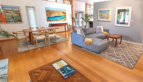 a living room with a couch and a table at Yallingup Villas in Yallingup