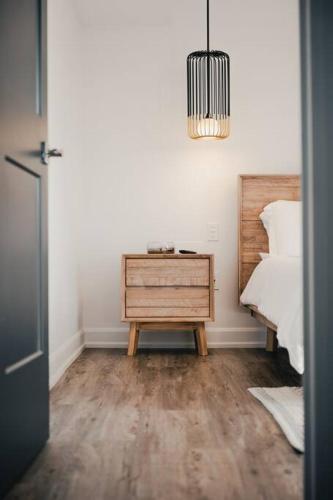 a room with a bed and a table with a nightstand at Khlozy Escape the ordinary. (Feonho) in Cornwall