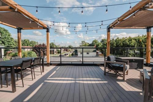 a patio with a table and chairs on a deck at Khlozy Escape the ordinary. (Feonho) in Cornwall