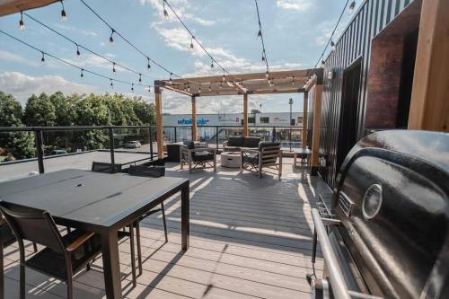a deck with a table and chairs on a balcony at Khlozy Escape the ordinary. (Feonho) in Cornwall