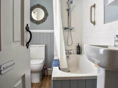 a bathroom with a tub and a sink and a toilet at The Nook in Bishop Auckland