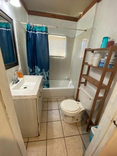 a bathroom with a toilet and a sink and a shower at House Rooms & RV Rooms Near LAX in Los Angeles