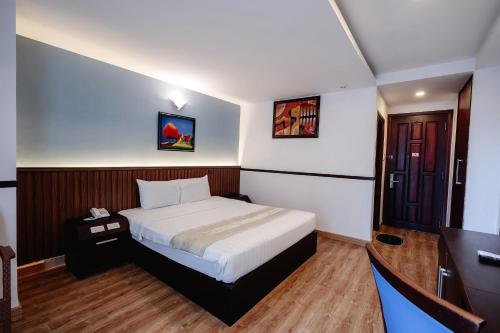 Ένα ή περισσότερα κρεβάτια σε δωμάτιο στο King Hotel