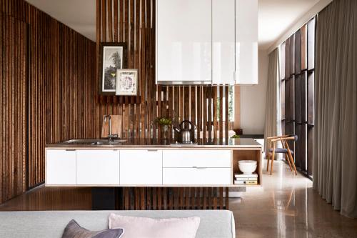 a kitchen with white cabinets and a sink at Drift House in Port Fairy