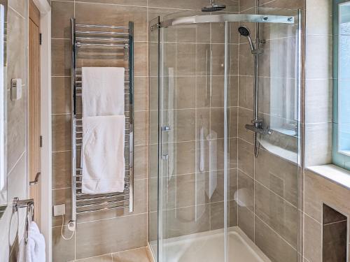 a bathroom with a shower with a glass door at Hogberts Hideaway in Carlton Colville