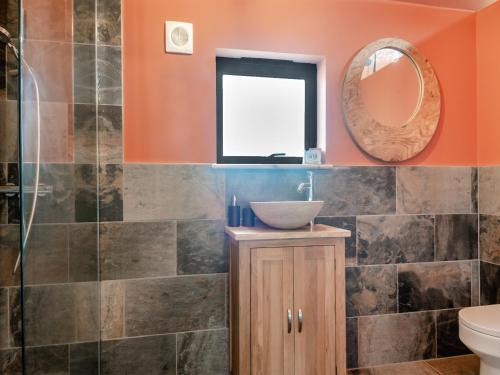 a bathroom with a sink and a mirror at Zambezi - Uk44827 in Holton