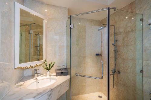 a bathroom with a sink and a shower at Alagon Saigon Hotel & Spa in Ho Chi Minh City