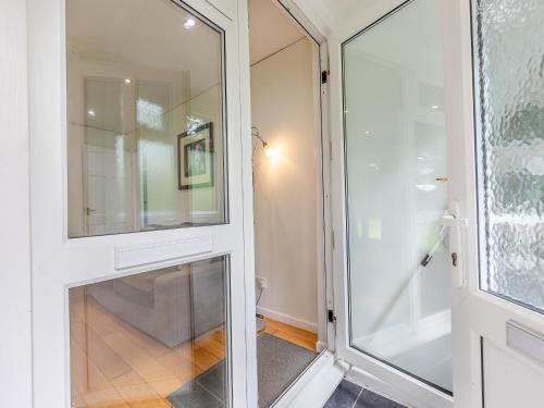 a glass door leading into a room with a hallway at Hollies - W43107 in Bradworthy