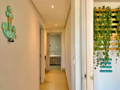 a hallway with a room filled with wine bottles at Apt FRENTE MAR MEAIPE COMPLETO in Guarapari