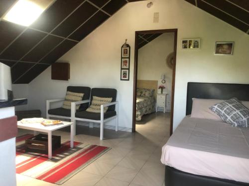 a bedroom with a bed and a table and chairs at Moradia São Romão in Torrão