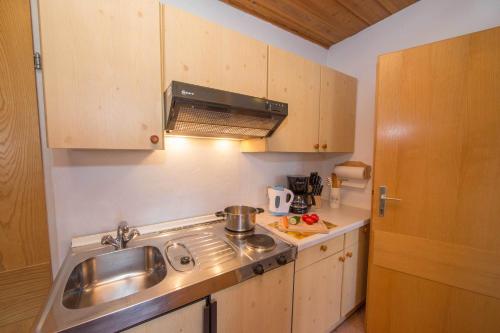 a small kitchen with a sink and a stove at Apartments Kitzsteinhorn in Zell am See