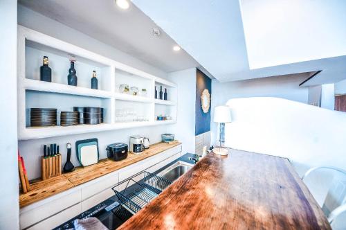 a kitchen with a wooden table and a sink at The House on the beach in Hayama