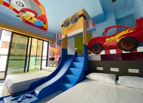 a bedroom with two beds and a car mural at Kaohsiung High Fun Hostel in Kaohsiung