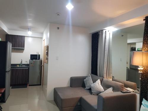 a living room with a couch and a kitchen at Affordable place to stay near cebu city in Cebu City