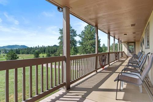 a row of chairs sitting on the porch of a house at Papa’s Place on Willow Creek in Custer