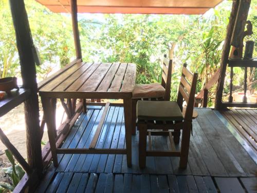 a wooden table and chairs on a wooden deck at Bangpo Village in Ban Bang Po