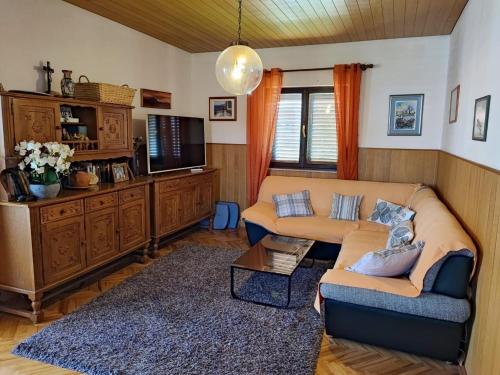 a living room with a couch and a tv at Apartment Dragi - 250 m from beach in Supetar