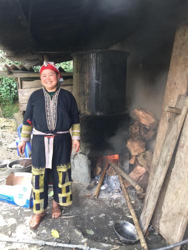 a woman standing in front of a stove at Sapa Paramount Hotel in Sa Pa