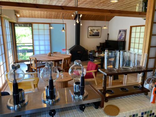 a dining room with tables and glass vases on tables at kakayama hutte in Muraoka