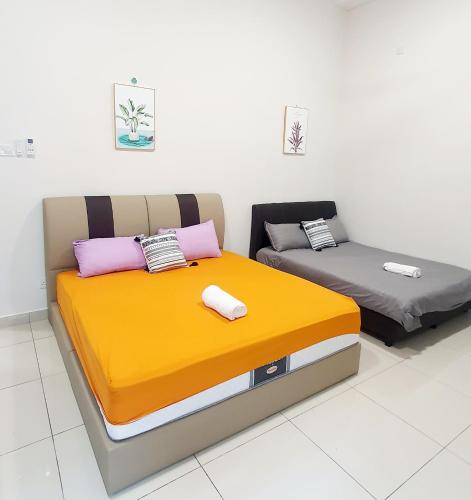 two beds sitting next to each other in a room at JOVIAL SingleStorey Bungalow 4Room10Pax `Alma in Bukit Mertajam