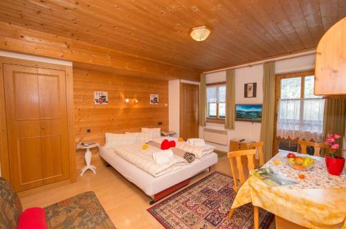 ein Schlafzimmer mit einem Bett und einem Tisch in einem Zimmer in der Unterkunft Apartments Kitzsteinhorn in Zell am See