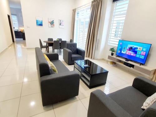 a living room with couches and a flat screen tv at JOVIAL SingleStorey Bungalow 4Room10Pax `Alma in Bukit Mertajam