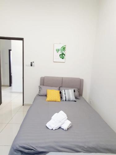 a bed with two towels on it in a room at JOVIAL SingleStorey Bungalow 4Room10Pax `Alma in Bukit Mertajam
