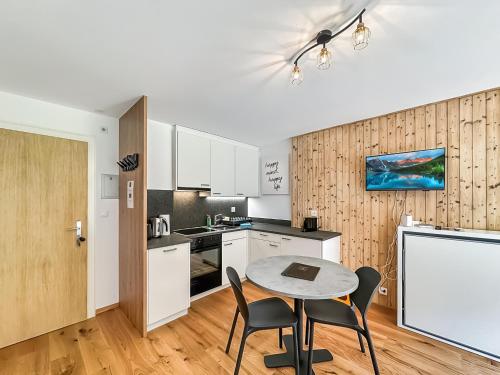 a kitchen and dining room with a table and chairs at Pied de piste de Thyon - 4 Vallees in Vex