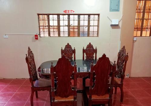 a dining room with a table and chairs at Footprints Hostel in Coron