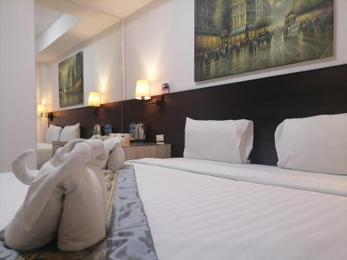 a bedroom with a large bed with an elephant headboard at Amici Miei Guest House in Patong Beach