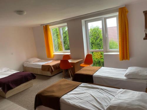 a room with three beds and a window at OWR Piramida 2 in Darlowko