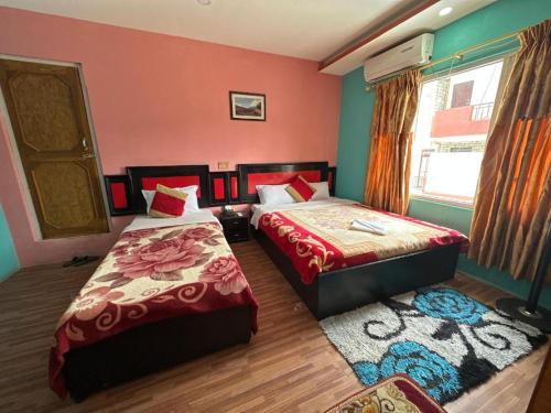 a bedroom with two beds and a window at Hotel Benju in Kusma