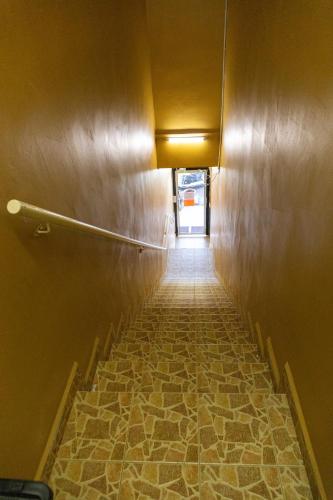 a hallway with a stone floor in a building at Familia Motel Kangar in Kangar