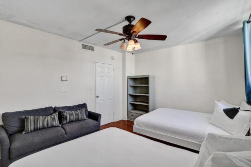 a living room with a couch and a ceiling fan at 2Bd Condo Christmas Retreat Pool Beachside in Hollywood