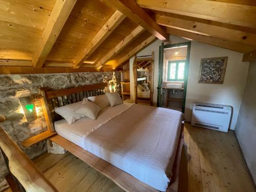 a bedroom with a large bed in a room with wooden ceilings at Villa Teza Hvar in Hvar