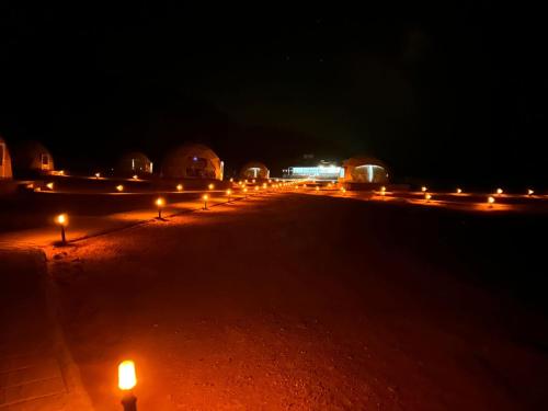 a row of lights on a road at night at Amanda Luxury Camp in Wadi Rum