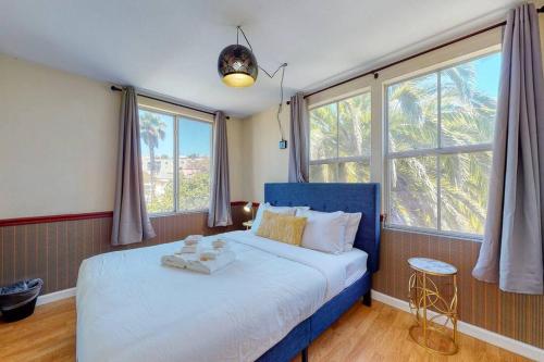 a bedroom with a blue bed with two towels on it at Beautiful Spacious House 2BR / 4BR in Silver Terrace in San Francisco
