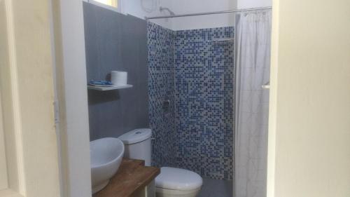 a small bathroom with a toilet and a shower at Gardenia House Rent Rooms in Bantayan Island