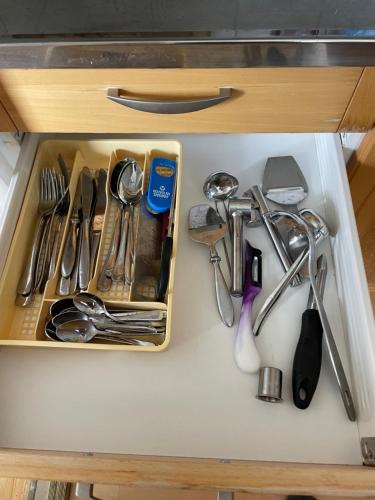a drawer filled with utensils on a counter at Valimontien residenssi in Kouvola
