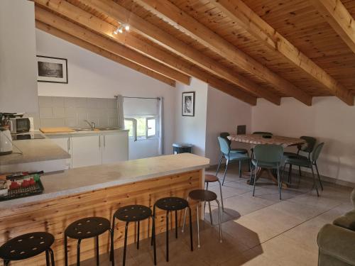 a kitchen and dining room with a table and chairs at Kouros apartment, Agios Nikolaos, Petriti in Ágios Nikólaos